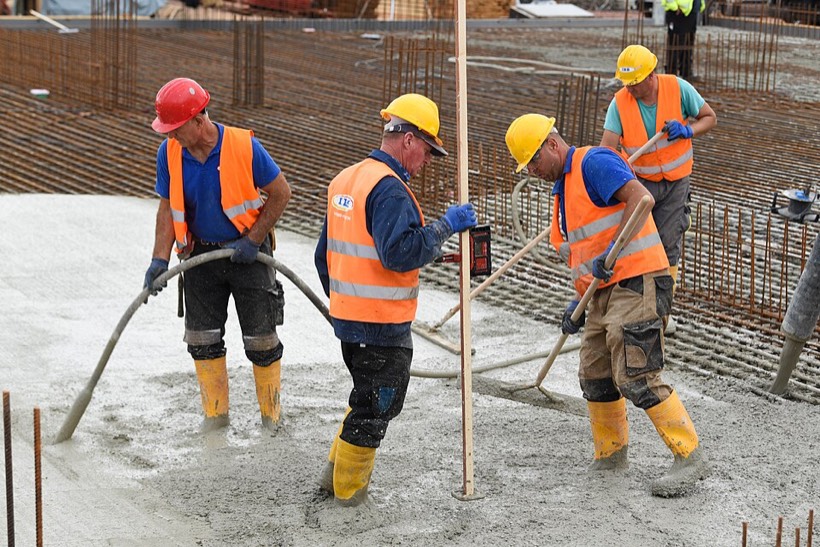 Workers pouring concrete