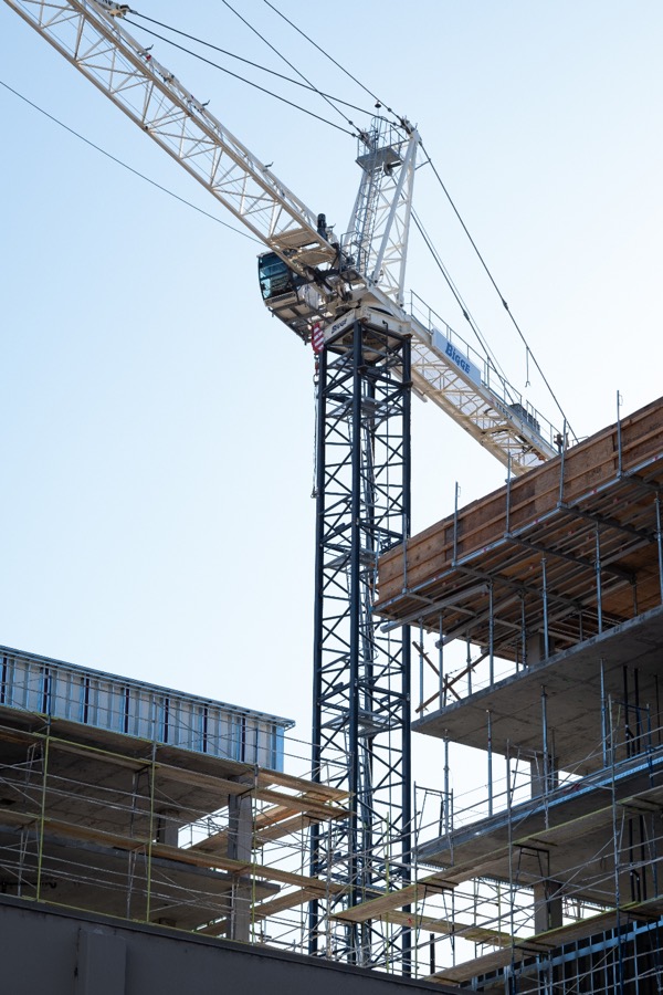 A building under construction with a crane