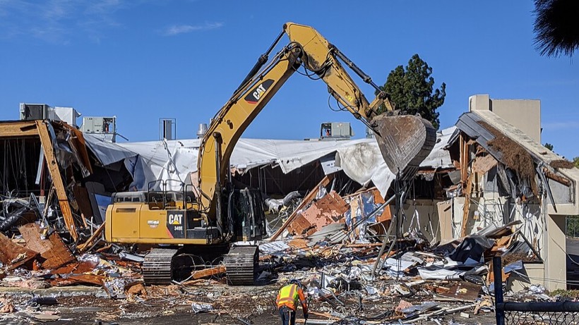 Excavator demolishing a building