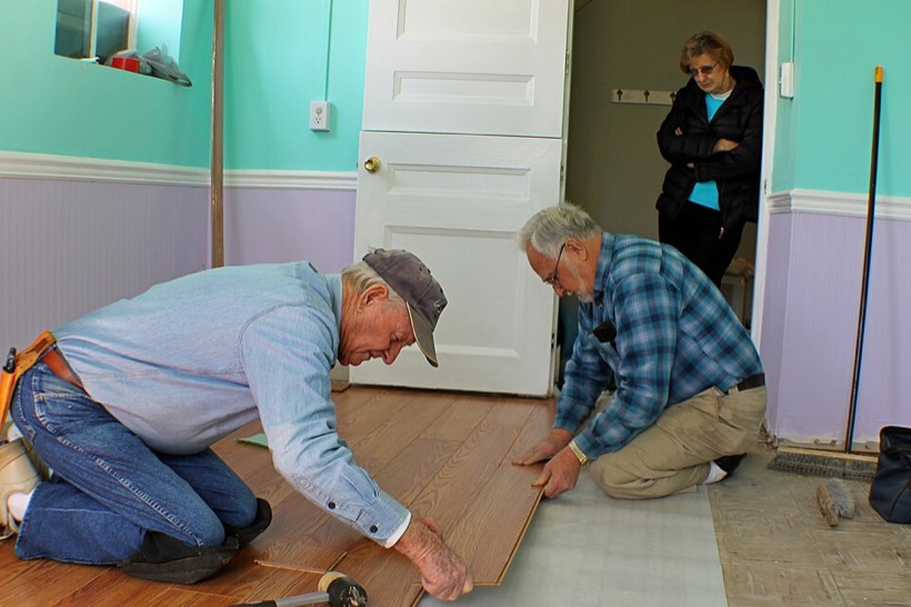Installers laying a wood floor