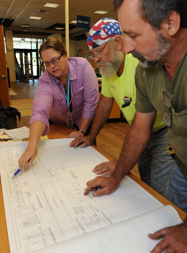 Contractors reviewing renovation plans